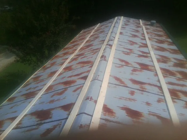 Rusted metal roof panels with new wood purlins before replacement — Storm Damage Roof Repair in Pontiac by Roofing Brothers